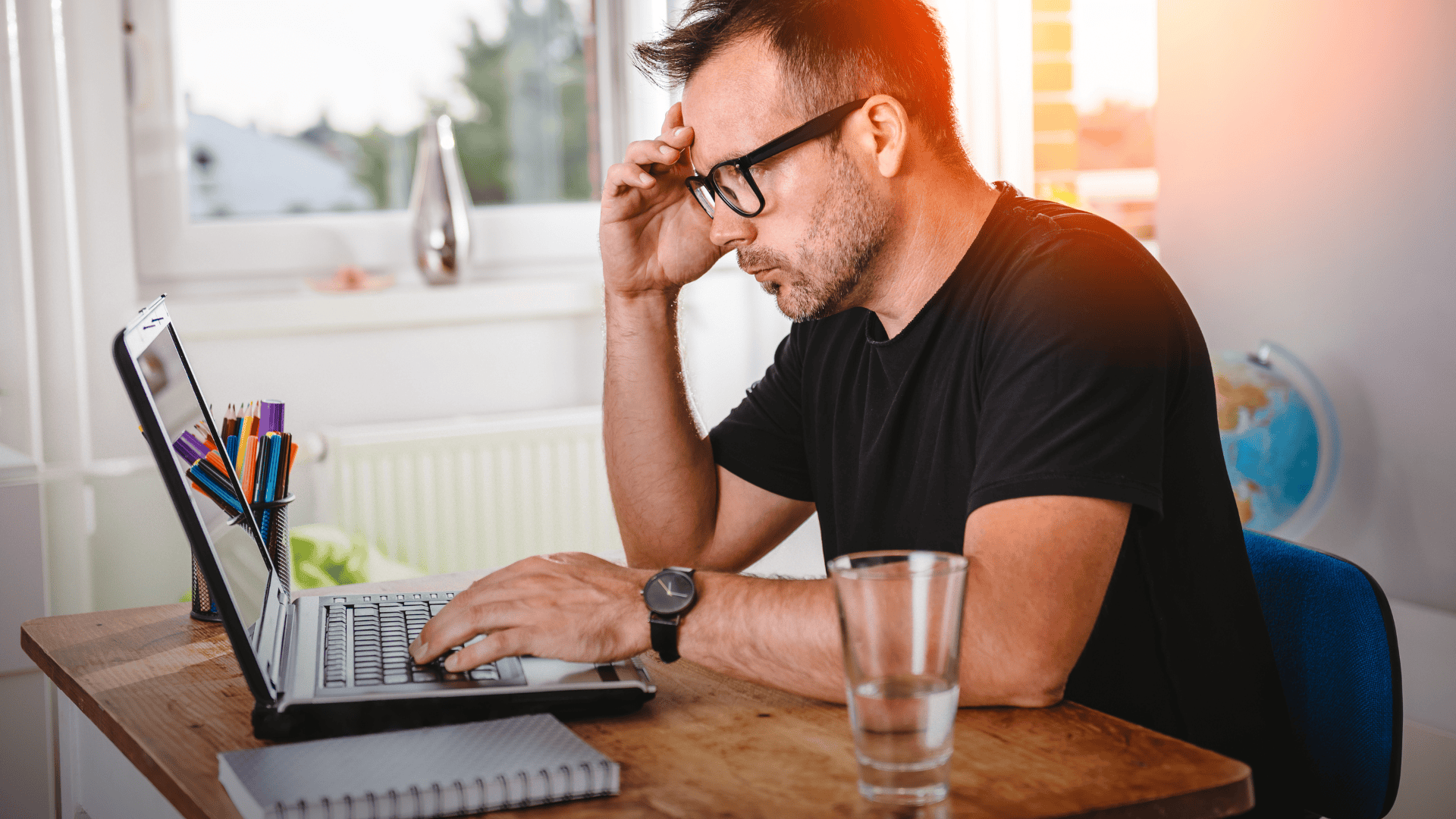 Frustrated job seeker looking stressed at his laptop, indicating burnout and the need to reset a job search that isn't working.